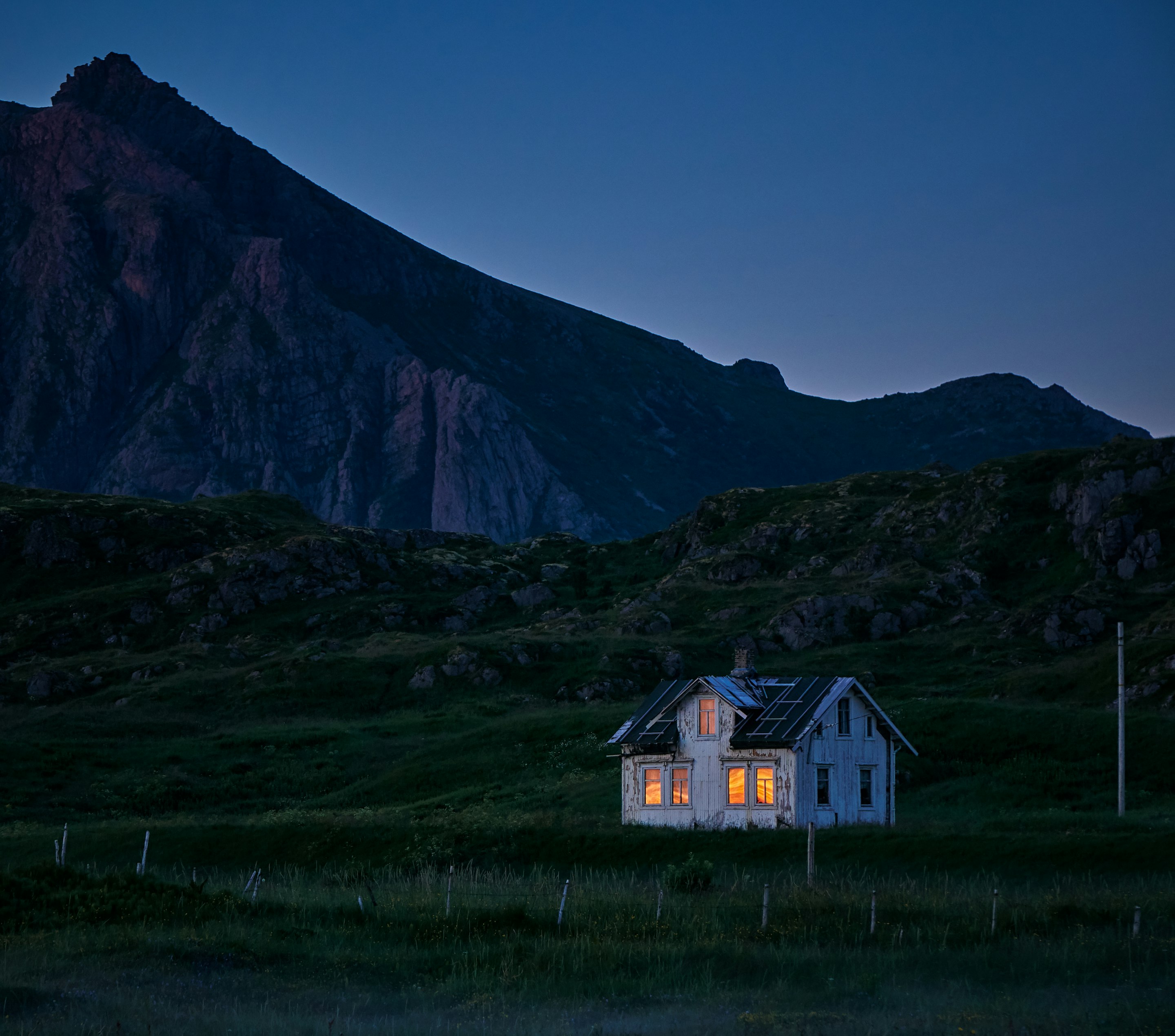 lighted house on green field